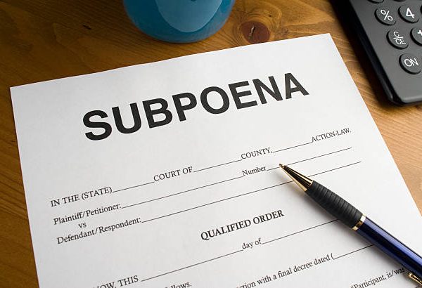Official looking court document for a subpoena on a desktop