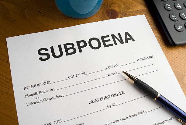 Official looking court document for a subpoena on a desktop